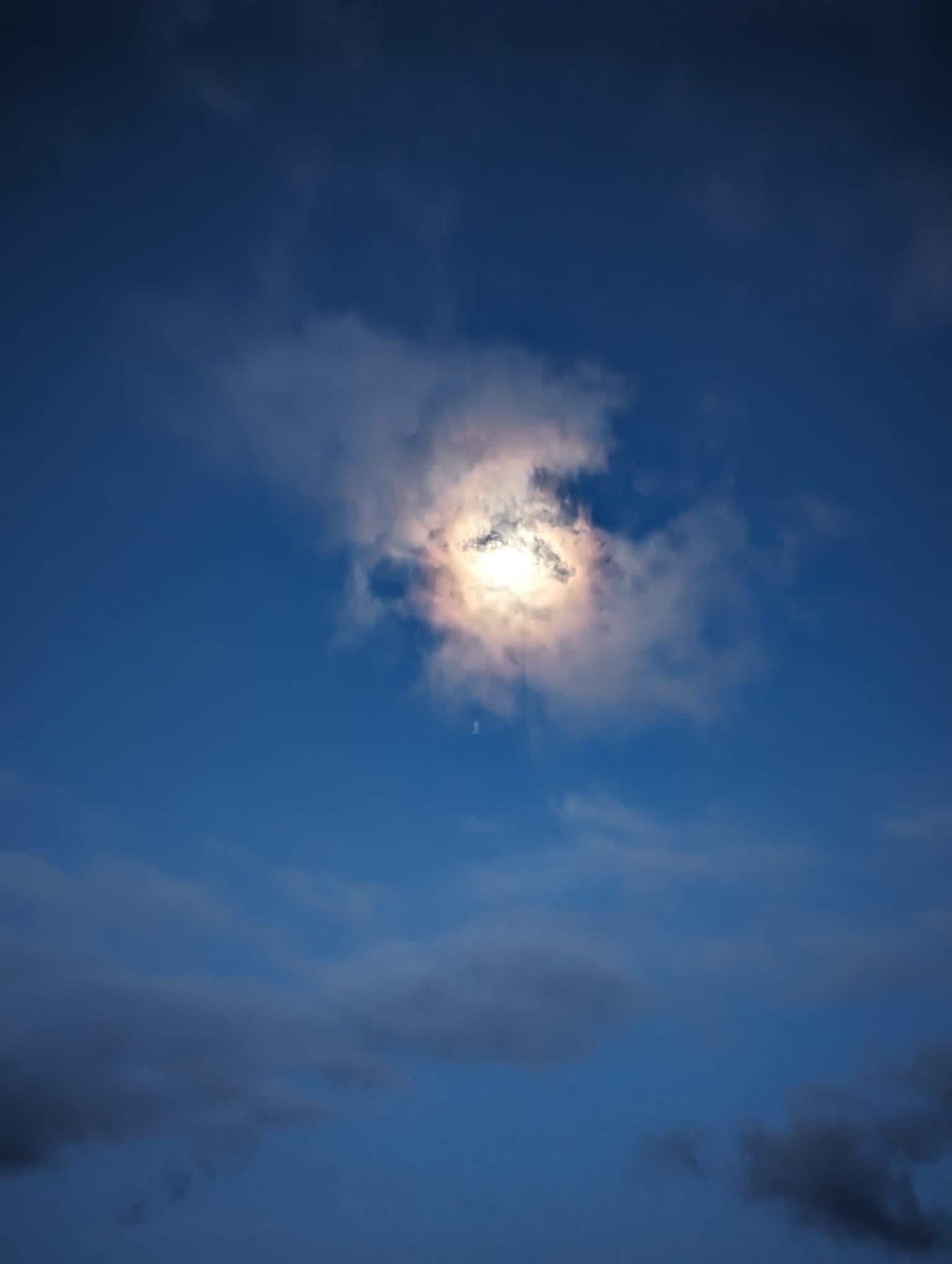 Bright sun breaking through clouds in a deep blue sky - symbolizing clarity and vision in challenging times